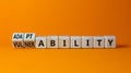 Vulnerability or adaptability symbol. Turned wooden cubes and changed words `vulnerability` to `adaptability`. Orange backgrou