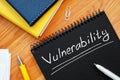 Vulnerability is written in white pencil on a black page.