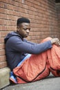 Vulnerable Teenage Boy Sleeping On The Street Royalty Free Stock Photo