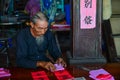 Writing chinese calligraphy on red paper