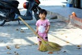 Vung Tau, Vietnam - January 28, 2018: Little Asian sweet girl with a broom