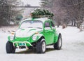 VW Bug Car Decorated With A Christmas Tree And Lights For The Holidays