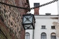 VYBORG, RUSSIA - OCTOBER 31, 2021: Old style lamp in Vyborg Castle. Vintage lamp hanging on a metal chain