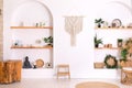 Wabi sabi interior with arch shelves with home decor. Stylish interior of living room