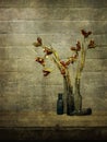 Wabi sabi still life with old bottles and dried stinking iris seed heads. Rustic interior.