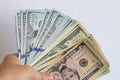 A wad of dollars in his hands on a white background. Dollar bills on a white background Royalty Free Stock Photo