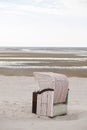 Wadden Sea Coast.Beach box on the sea coast.Walks and rest on the Wadden Sea.Beach wicker boxes set on white sand.Fer Royalty Free Stock Photo