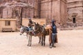 Bedouin drovers stand with their riding donkeys waiting for tourists in Petra - the capital of the Nabatean kingdom in Wadi Musa c Royalty Free Stock Photo