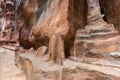 Remains of statues carved into the rock of canyon leading to Petra - the capital of the Nabatean kingdom in Wadi Musa city in Jord Royalty Free Stock Photo