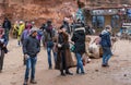 Tourists, vendors and drivers - Bedouins, camels and Bedouin souvenir shops in the square in front of Petra near Wadi Musa city in