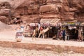 Bedouin rides on the camel near souvenir shops in Nabatean Kingdom of Petra in Wadi Musa city in Jordan