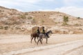 Two Jordanian mounted policemen patrol tourist route in Petra in Wadi Musa city in Jordan