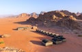 Wadi Rum desert, Jordan. Beautiful aerial view of bedouin camp at sunset from above with tents lined up and red rock formations Royalty Free Stock Photo