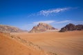 Wadi Rum desert in Jordan. Beautiful red pink sand dunes and rocky mountains, beautiful blue sky Royalty Free Stock Photo