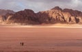 Wadi Rum desert landscape in sunrise, with family riding camels. Famous travel and adventure destination in Jordan Royalty Free Stock Photo