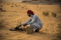 Wadi Rum desert Jordan 17-9-2017 A Bedouin man, makes a fire in the middle of the Wadi rum desert between stones, puts a jar on it