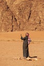 An Arabic man is searching for connection in the middle of a desert Royalty Free Stock Photo