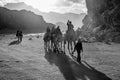 Jordan, Wadi Rum desert, people, camels on safari Royalty Free Stock Photo