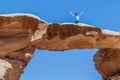 WADI RUM, JORDAN - MARCH 26, 2017: Tourist on Burdah rock bridge in Wadi Rum desert, Jord Royalty Free Stock Photo