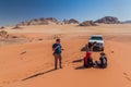 WADI RUM, JORDAN - MARCH 26, 2017: 4WD Toyota with tourists and a local Bedouin tour guide in Wadi Rum desert, Jord Royalty Free Stock Photo