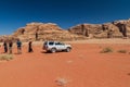 WADI RUM, JORDAN - MARCH 26, 2017: 4WD Toyota with tourists and a local Bedouin in Wadi Rum desert, Jord Royalty Free Stock Photo