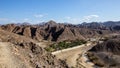 Wadi Shawka Dam panorama, with empty dam, dry riverbed and rocky Hajar Mountains, United Arab Emirates Royalty Free Stock Photo