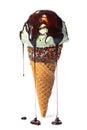 Wafer cone decorated colorful sprinkles and chocolate icing with green scoop of ice cream and current glaze isolated on white