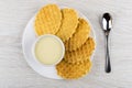 Wafer cookies, bowl with condensed milk in white plate, teaspoon Royalty Free Stock Photo