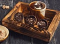 Wafer cups with cream and chocolate chips on a wooden tray. Royalty Free Stock Photo