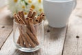 Wafer roll sticks cream rolls with coffee on wood table. Selecti Royalty Free Stock Photo