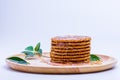 Wafer sprinkled with honey on wooden tray ready to serve Royalty Free Stock Photo