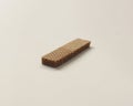 Wafers with chocolate flavored cream on a white and wooden background.