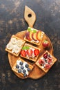 Wafers with cream and berries on a cutting board. The view from above, flat lay. Royalty Free Stock Photo