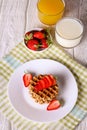 Waffels with strawberry on a white plate