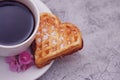 Waffle biscuits in shape of heart with cup of coffee on wooden background for Valentines day, top view Royalty Free Stock Photo