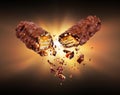 Waffle chocolate bar with nuts broken into two parts in the dark Royalty Free Stock Photo