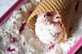 Waffel cone filled with homemade Ice cream made with Greek yogurt and raspberry. Summer refreshment and healthy dessert. Recipe