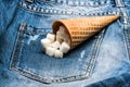 Waffle cone with refined sugar on denim background. Cone full of refined sugar on jeans. Diet concept. Cone for ice Royalty Free Stock Photo