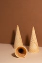 The waffle cones without ice-cream on beige background. Close-up. Shadows on the wall. Ice-cream design. Waffle cone unicorn