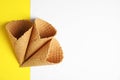 Waffle empty ice cream cones on color background. Space for text Royalty Free Stock Photo
