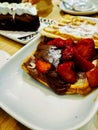 A waffle with strawberries, chocolate and sugar for the breakfast Royalty Free Stock Photo