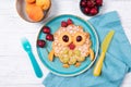 Waffle with fruits and berries in the shape of cute owl with balloons, food for kids idea, top view Royalty Free Stock Photo