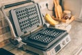 Waffle iron on kitchen table. Home kitchen interior Royalty Free Stock Photo