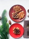 Waffle in red plates with green leaves