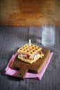 Waffle sandwich with cheese, prosciutto and chanterelles, gourmet