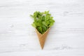 Waffle sweet cone with mint leaves over white wooden surface, from above. Flat lay. Top view. Royalty Free Stock Photo