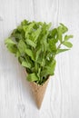 Waffle sweet ice cream cone with mint on white wooden background, top view. Flat lay, overhead Royalty Free Stock Photo