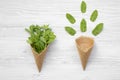 Waffle sweet ice cream cones with mint on white wooden background, top view. Flat lay, overhead Royalty Free Stock Photo