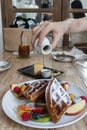 Waffle topped with mixed fruits, syrup, whipped cream, icing sugar and freshly chopped berries. Royalty Free Stock Photo