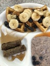 waffle triangles, banana, blueberries, syrup, sausage, yogurt